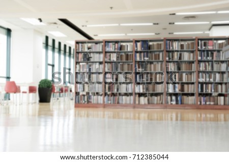 Blurred books in library for background. Royalty-Free Stock Photo #712385044