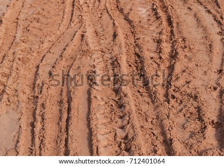 tire track of many vehicle on soil mud road in countryside in rainy season