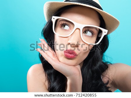 Young woman taking a selfie on a blue background