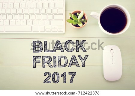 Black Friday 2015 text with workstation on a light green wooden desk