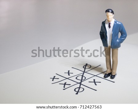 Business and direction concept. Businessman small figure standing on paper and center of circle with more arrows point to many direction.Business concept idea.