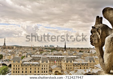 Gargoyle on Notre Dame de Paris on background of skyline of Paris, France