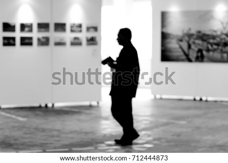 Visitor at photography art gallery exhibition display