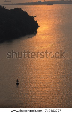 Reflection of Setting Sun in water Royalty-Free Stock Photo #712463797