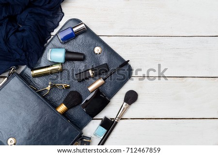 Handbag and cosmetics on a white wooden background. Mockup