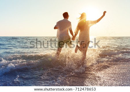 Happy young couple enjoying the sea Royalty-Free Stock Photo #712478653
