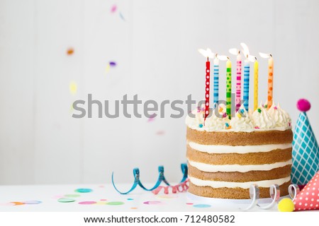 Birthday cake with colorful candles at a birthday party