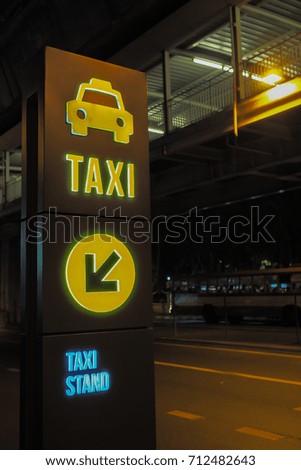 Sign of Taxi stand with road nigh background
