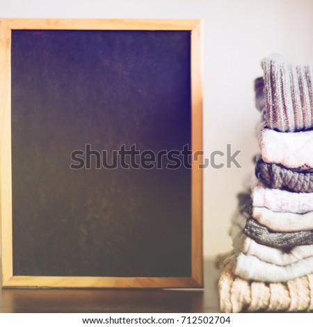 knit warm clothes neatly folded on the labels, texts, copyspace