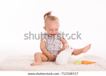blond girl in a studio with white rabbit
