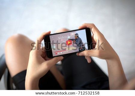 video tutorial concept.Female hands holding mobile phone Royalty-Free Stock Photo #712532158