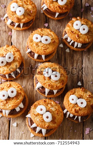 Peanut cookie monsters for helouinna close-up on the table. top view from above vertical
