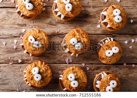 Halloween background: cookies monsters close-up on the table. top view from above horizontal
