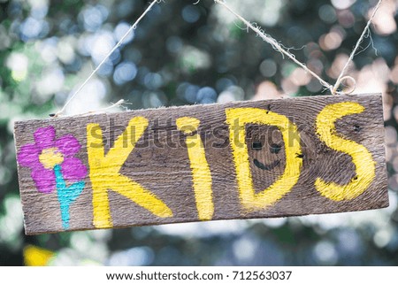 the kids inscription on a wooden sign hanging on a rope, the concept of children and children's holiday