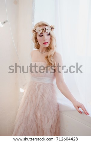 picture of young blonde woman wearing wreath of flowers, spring tender and romantic portrait