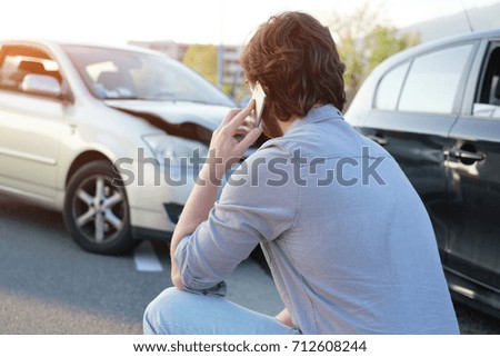 Man calling help after a car crash accident on the road Royalty-Free Stock Photo #712608244