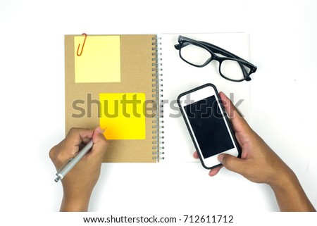 Business workplace from top smart phone, glasses, notebook on white background.