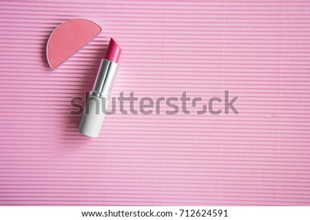 pink lip stick and brush on cosmetics for beauty of woman and girl on sweet pink background 