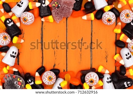 Halloween candy frame over an old orange wood background