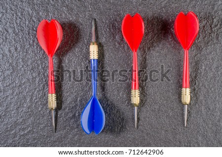 Red and blue darts on the granite background.idea business goal.