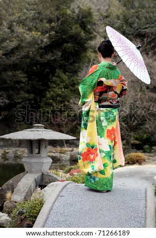 Women in kimono with umbrella on the bridge