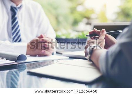 Businessmen and their customer are negotiating a trade agreement. Royalty-Free Stock Photo #712666468