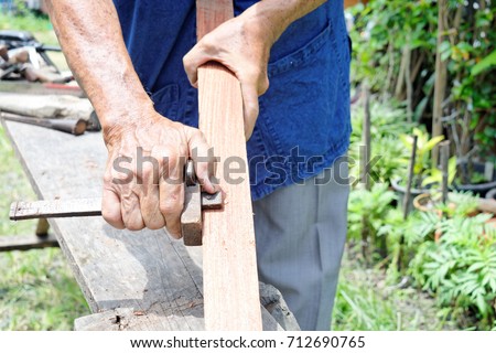 Carpenter using marking gage on wooden stick Royalty-Free Stock Photo #712690765