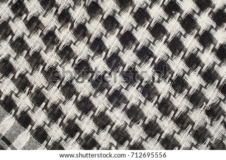 Background texture, pattern. Scarf wool like Yasir Arafat. The Palestinian keffiyeh  is a gender-neutral chequered black and white scarf that is usually worn around the neck or head. 