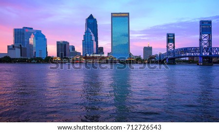 Jacksonville, Florida city skyline over the St. John's River at sunset (logos blurred for commercial use)