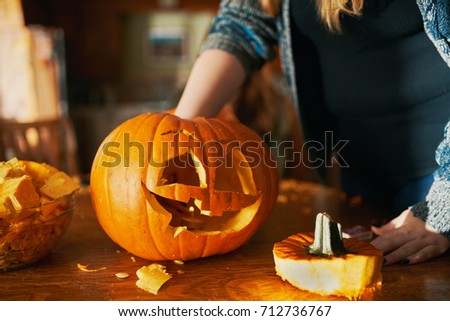 family fun activity - carved pumpkins into jack-o-lanterns for halloween close up Royalty-Free Stock Photo #712736767