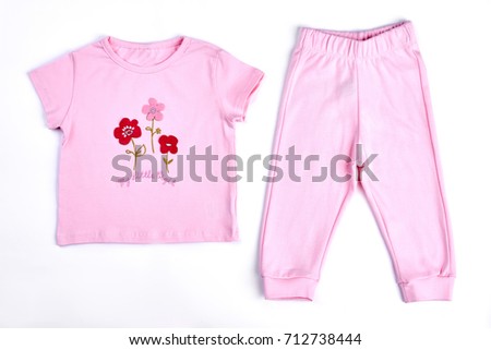 Baby-girl pink t-shirt and trousers. Newborn baby girl adorable pink cotton suit on white background. Toddler girl beautiful apparel on sale.