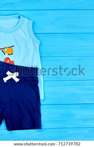 Infant boys outfit, copy space. Toddler boys summer fashion clothes, top view. Shorts and t-shirt for little boys on sale.