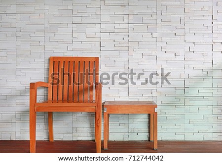 Wood chair set against modern brick wall