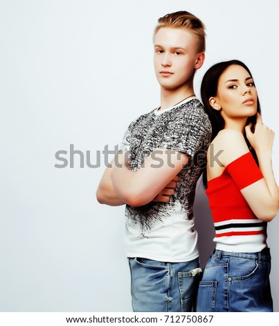 young pretty teenage couple, hipster guy with his girlfriend happy smiling and hugging isolated on white background, lifestyle people concept 