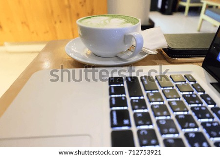notebook and green tea cup.