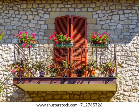 Typical balcony with bougainvillea flowers, Italy