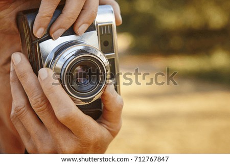 Woman taking pictures with vintage camera. Travel background.  