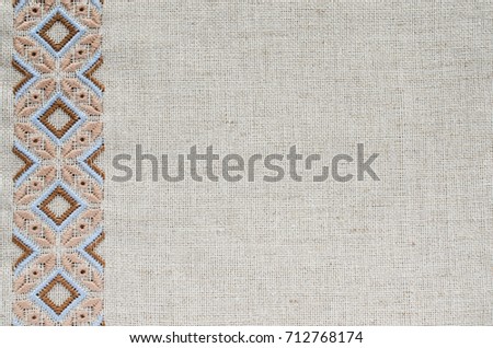 Embroidered fragment on flax by brown and beige cotton threads. Embroidery texture flat stitch. Ukrainian ethnic ornament. Royalty-Free Stock Photo #712768174