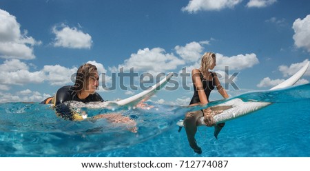 Couple swimming with surf and relax in ocean
