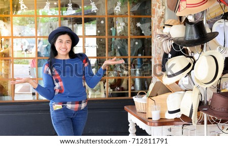Asian woman present hat fashion in her store