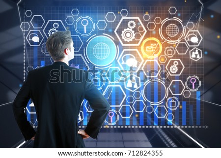 Back view of young businessman looking at digital business screen. Innovation concept. Double exposure 