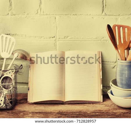 Retro kitchen utensils on wooden table