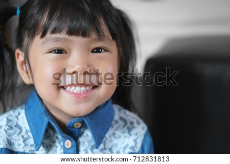 Asian children cute or kid girl wearing jeans or cowboy suit for fashion and smile white teeth with small eye and happy for background with space