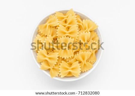 Pasta farfalle close-up in white bowl, on white background