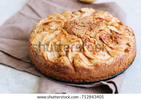 Easy apple tea cake on a linen napkin. White background and close up.