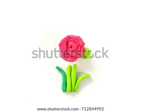 Beautiful pink roses flower with green leaves made from plasticine (clay)put in the center place on a white background