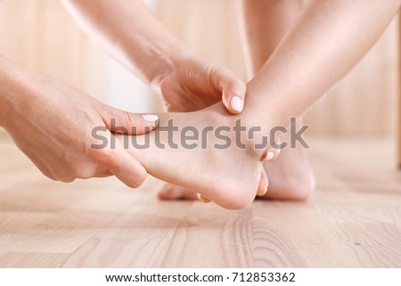 Foot injury. First aid, the woman checks the baby's foot