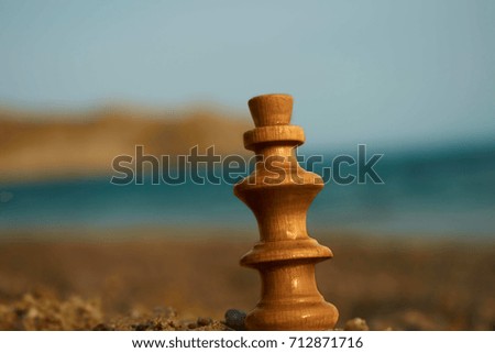Chess piece in the beach sand chess king on Greek islands beaches sand with sea and sky background 