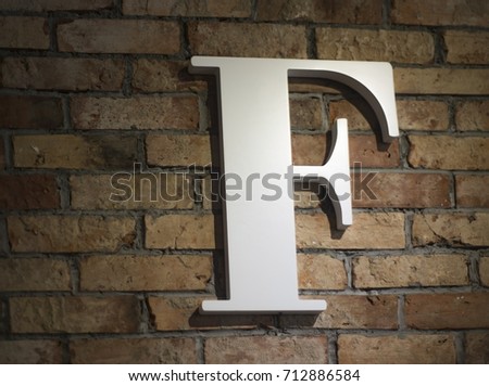 The letter f on the brick wall, the letter on a red brick wall
 Royalty-Free Stock Photo #712886584