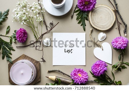 Creative mock up of accessories and flowers on the table. Bright and stylish concept on a beige background. View from above. Mock up.
